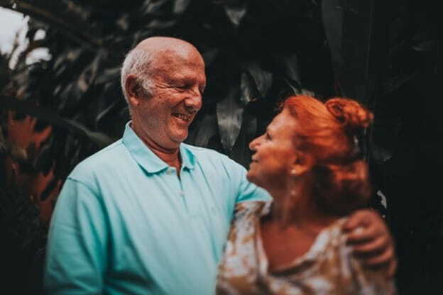 smiling elderly couple hugging