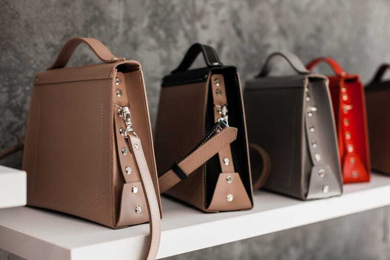 women leather handbags in a row