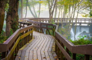 amazing wooden bridge over the wild lake in jajce, bosnia. wooden bridge walkway.
