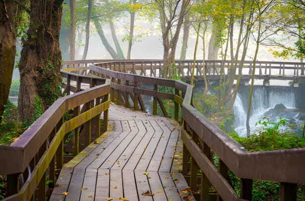 amazing wooden bridge over the wild lake in jajce, bosnia. wooden bridge walkway.