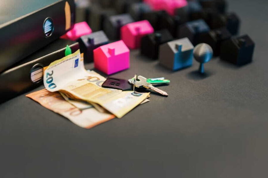 real estate investment with miniature houses and euro bills